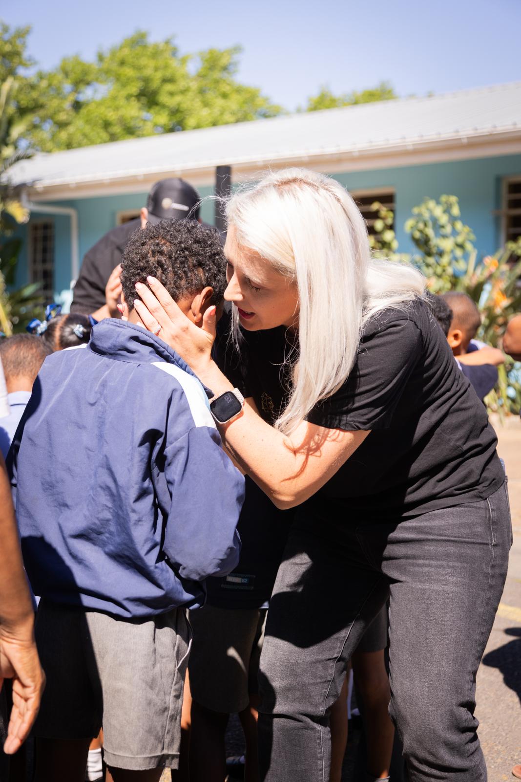 Ministry team praying over student at school outreach